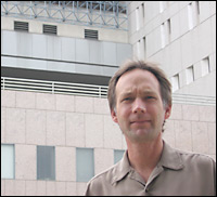 Jim Gates stands in front of the Los Angeles Metropolitan Detention Center.