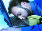 A man asleep on his laptop. A man asleep on his laptop.