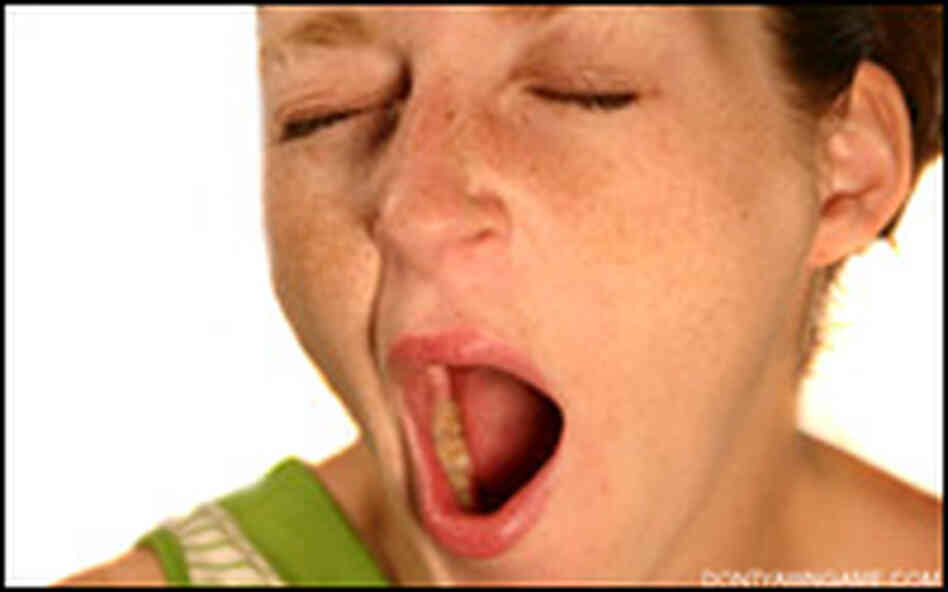A girl yawning.