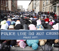 Women pray during a service for the 10 victims of a house fire in New York.