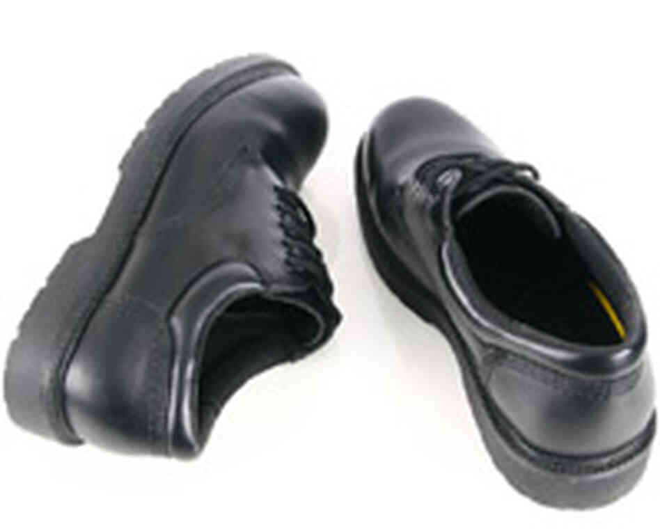 A shiny pair of black shoes. A shiny pair of black shoes.