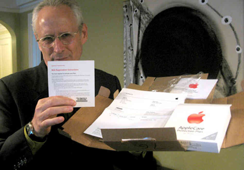 David Ross, holding a box containing his iPhone warranty. David Ross, holding a box containing his iPhone warranty.