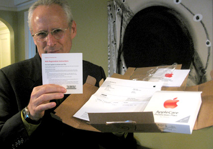 David Ross, holding a box containing his iPhone warranty.