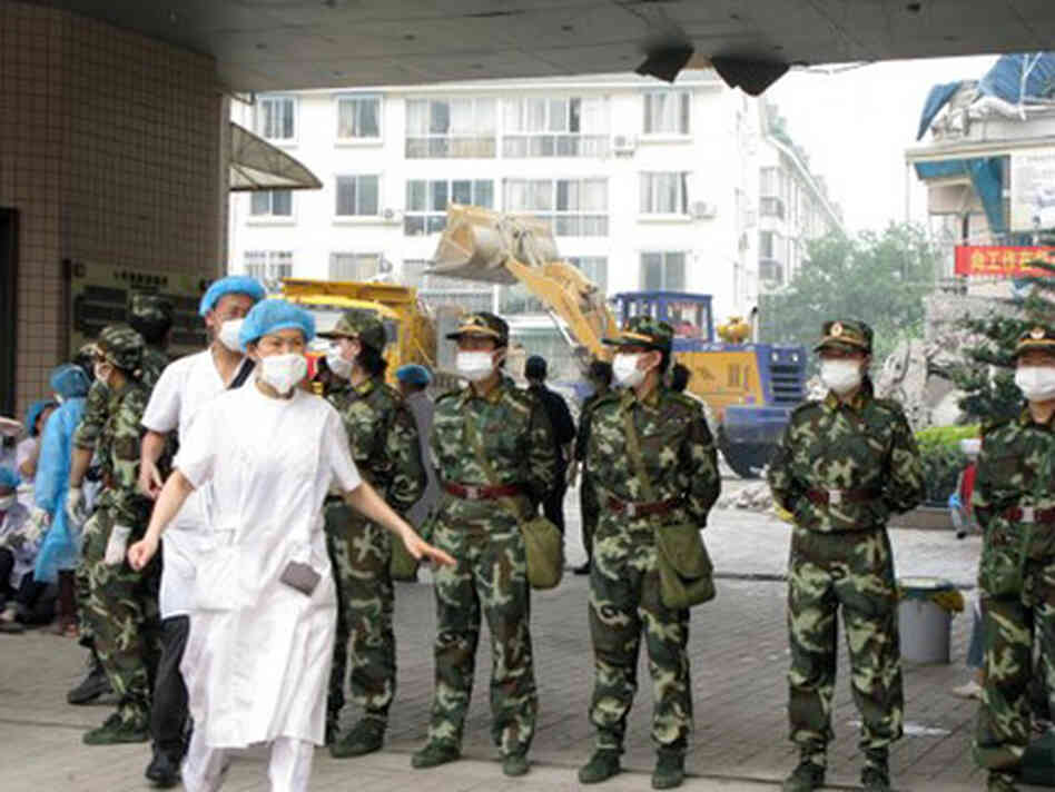 Hospital workers outside the traditional Chinese Medicine Hospital in Dujiangyan, China, in 2008. Ph Hospital workers outside the traditional Chinese Medicine Hospital in Dujiangyan, China, in 2008. Ph