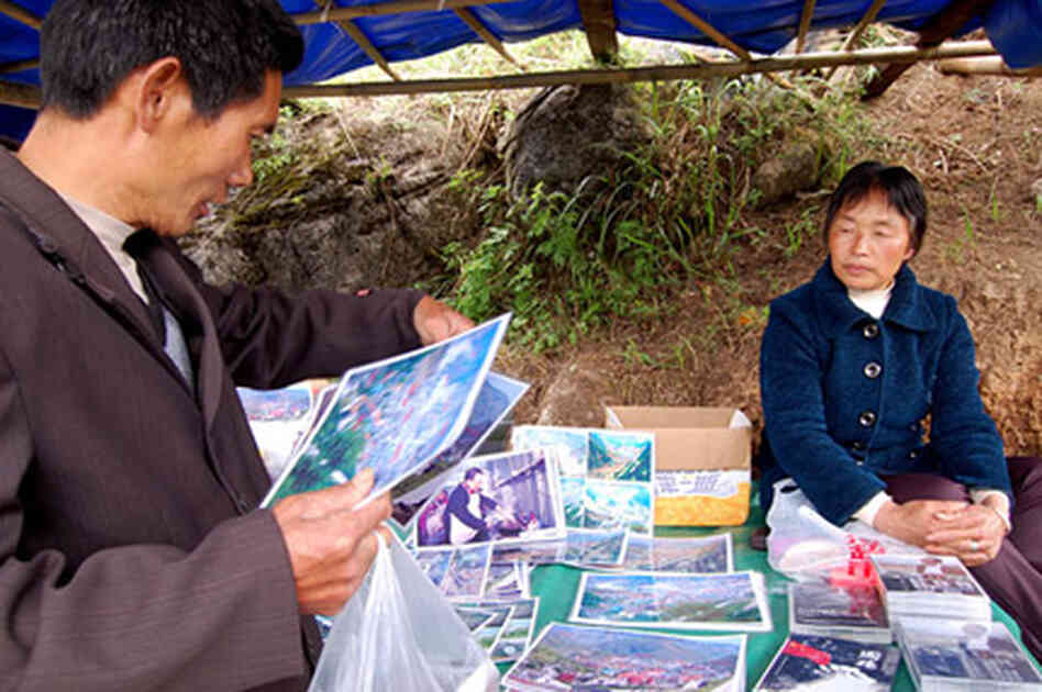 Local vendor Mu Zhenxian lost 16 relatives in the quake. She now sells photos and DVDs of earthquake Local vendor Mu Zhenxian lost 16 relatives in the quake. She now sells photos and DVDs of earthquake