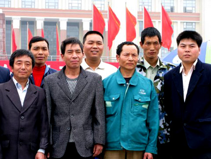 A group of me pose for a photo in front of the iconic statue of Chairman Mao in Tianfu Square in Chengdu, China. Photo: Melissa Block, NPR.
