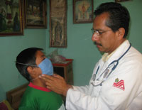 A LaGloria doctor checks a boy wearing a mask during swine flu outbreak. Photo: Carrie Kahn, NPR.