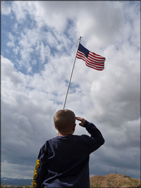 Child salutes American flag