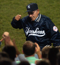 Famed N.Y. Yankees coach Yogi Berra salutes the crowd
