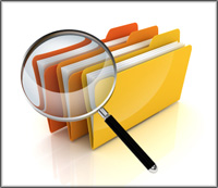 magnifying glass lokoing through paper folders