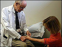 Dr. Lauro Halstead checks a polio patient's thumb