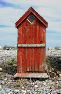 picture of an old, red outhouse