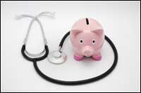 piggy bank stands next to stethoscope