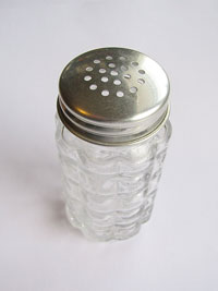 empty salt shaker sits on table