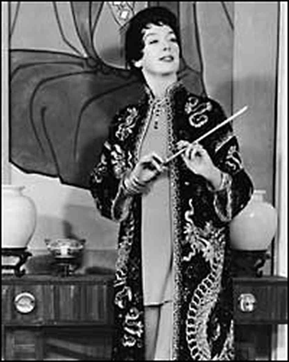 Rosalind Russell, as Auntie Mame, in a kimono with cigarette holder Rosalind Russell, as Auntie Mame, in a kimono with cigarette holder