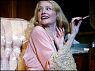 Patricia Clarkson smiles, gesturing with a cigarette holder. Patricia Clarkson smiles, gesturing with a cigarette holder.