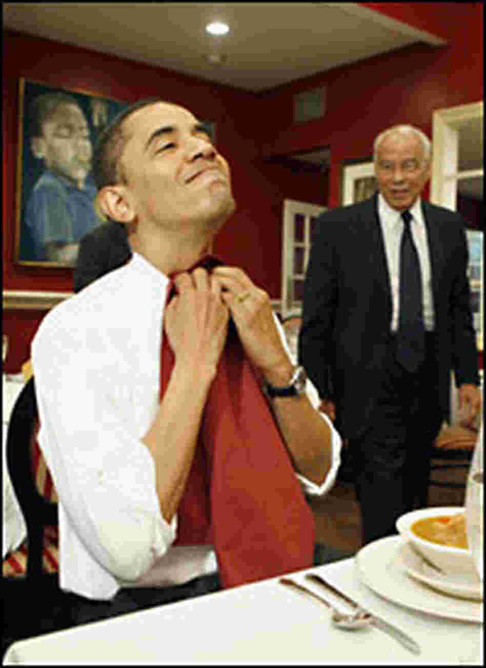 Barack Obama puts on a napkin preparing to eat Barack Obama puts on a napkin preparing to eat