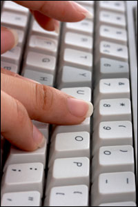 fingers typing on a keyboard