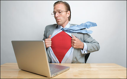 man at laptop revealing superhero outfit