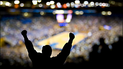 Sports fan cheering at a basketball game