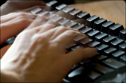 fingers typing on a keyboard