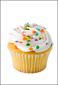 cupcake with white icing and sprinkles