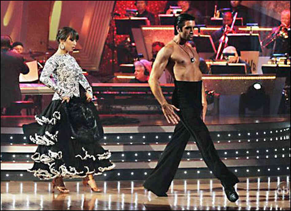Cheryl Burke and Gilles Marini, who has his shirt off Cheryl Burke and Gilles Marini, who has his shirt off