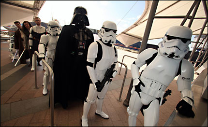A variety of Star Wars characters stand in line