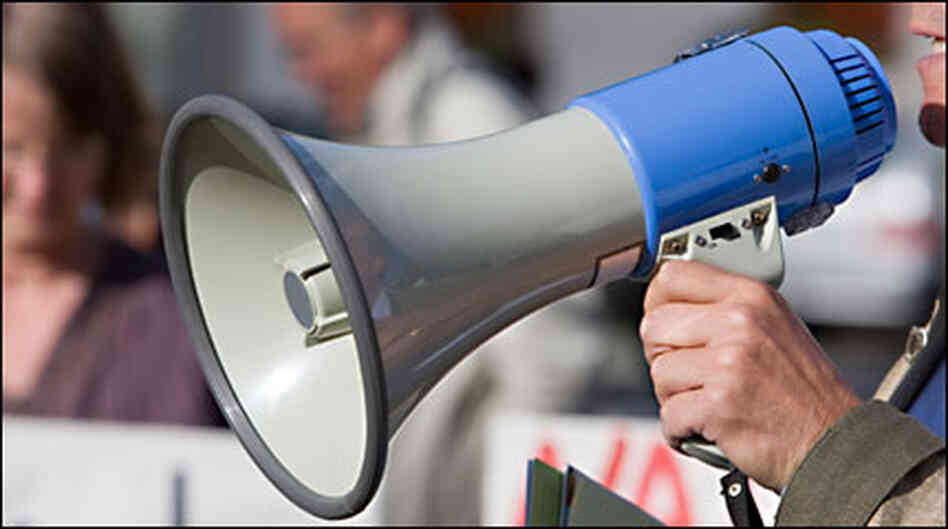 hand holding a bullhorn hand holding a bullhorn