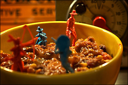Toy Army men sinking into a bowl of chili