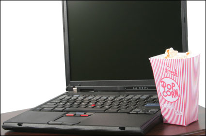 a tub of popcorn and a laptop