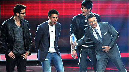 Kris Allen looks shocked upon hearing the news that he would be in American Idol's final two