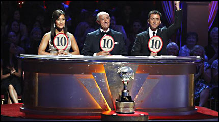 The judges of Dancing With The Stars hold up their scoring paddles