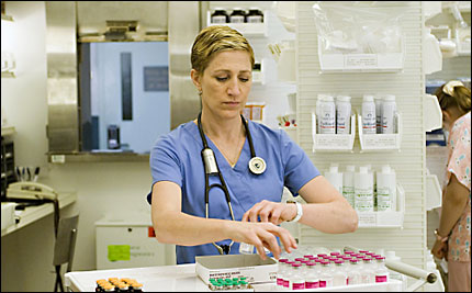 Edie Falco as Nurse Jackie on Showtime, looking over medications