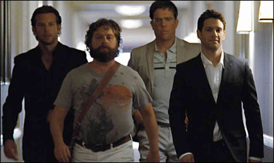 Bradley Cooper, Zach Galifianakis, Ed Helms, and Justin Bartha marching down a hallway in 'The Hango Bradley Cooper, Zach Galifianakis, Ed Helms, and Justin Bartha marching down a hallway in 'The Hango