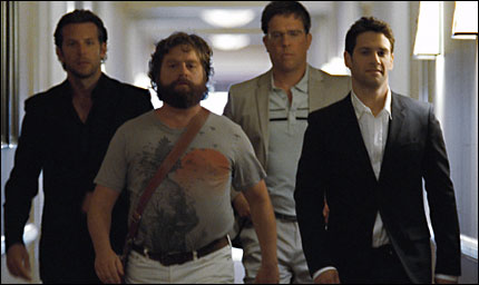 Bradley Cooper, Zach Galifianakis, Ed Helms, and Justin Bartha marching down a hallway in 'The Hangover'