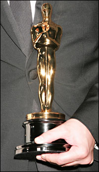 a hand holding an Oscar statuette