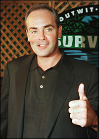 Richard Hatch gives a thumbs-up at a Survivor party in 2000