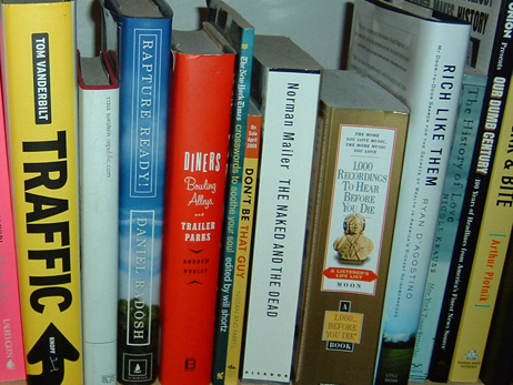 A section of bookshelf full of books.