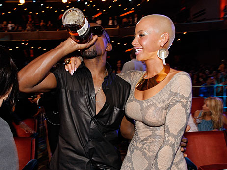 Kanye West drinks from a bottle and stands with Amber Rose at the MTV Video Music Awards on September 13, 2009.