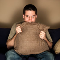 Scared man cringing in fear.
