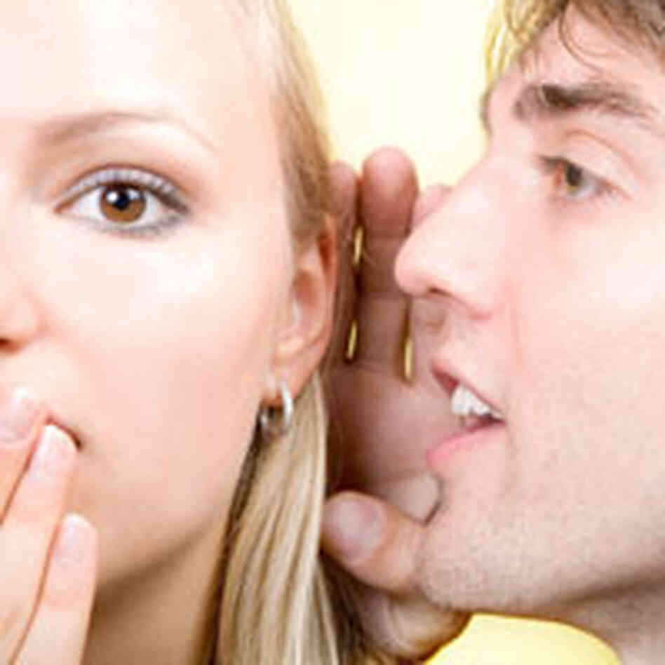 man whispering to a woman. man whispering to a woman.