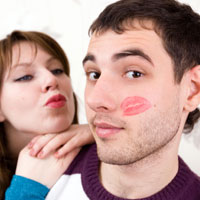 man with lipstick kiss on his face.