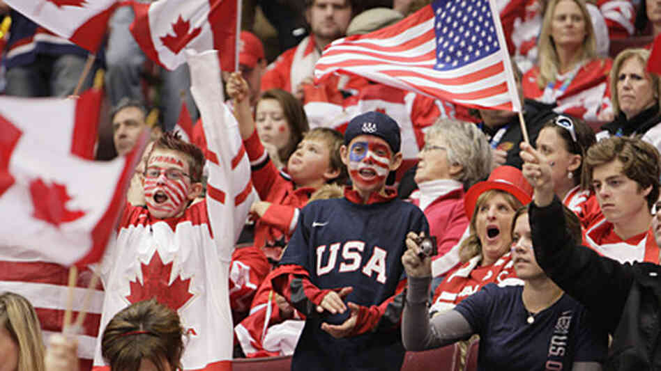 USA and Canada fans cheer at Sunday night's hockey game. USA and Canada fans cheer at Sunday night's hockey game.
