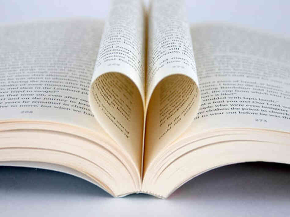 A book with the pages folded into a heart. A book with the pages folded into a heart.