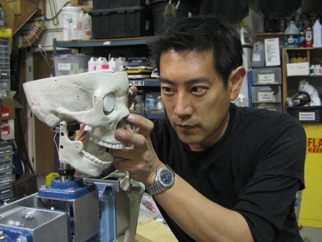 Grant Imahara works on the robot skeleton.