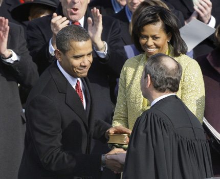 President Barack Obama, left, shakes hands with Chief Justice John Roberts after taking the oath of office at the U.S. Capitol in Washington, Tuesday, Jan. 20, 2009. At right rear is first lady Michelle Obama. AP Photo/Elise Amendola.