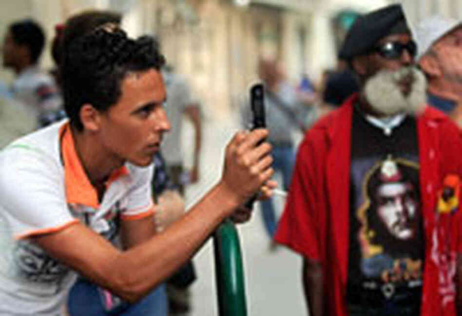A Cuban man takes pictures with his new cell phone in Havana. A Cuban man takes pictures with his new cell phone in Havana.