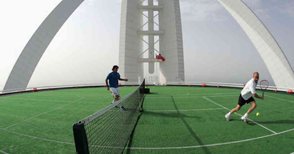 Roger Federer and Andre Agassi playing tennis. Roger Federer and Andre Agassi playing tennis.