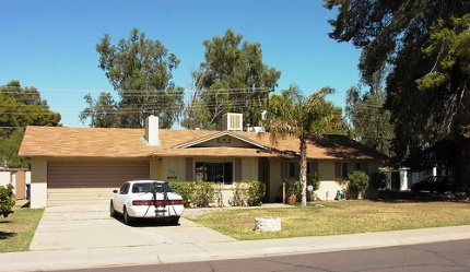 a typical suburban home and parched lawn